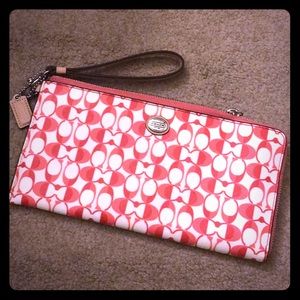 Pink and white Coach wristlet